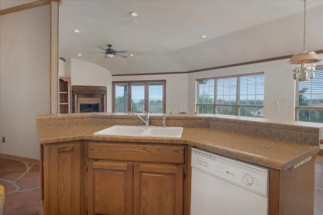 a kitchen with stainless steel appliances granite countertop a sink a stove and cabinets