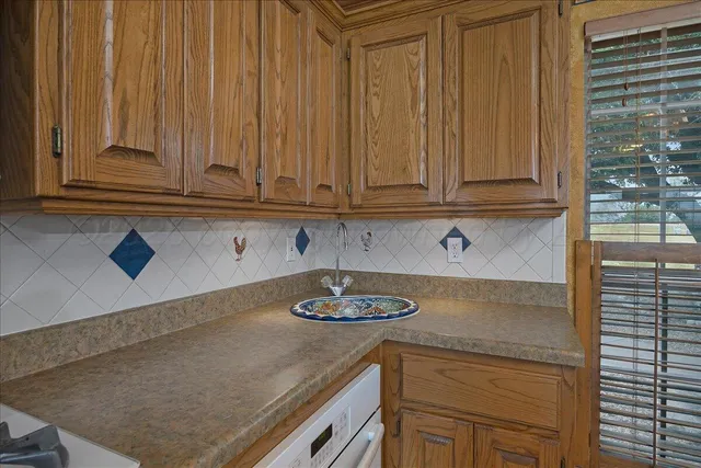 a view of an empty room with a chandelier fan