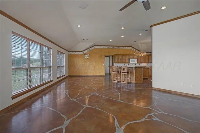 a dining hall with stainless steel appliances a dining table and chairs with wide window