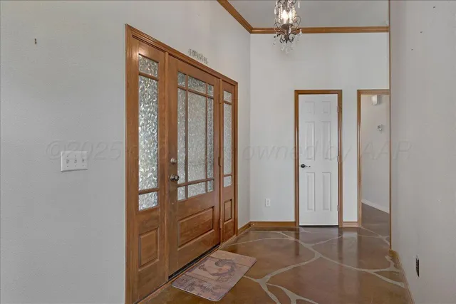 a view of an empty room with a fireplace and a window