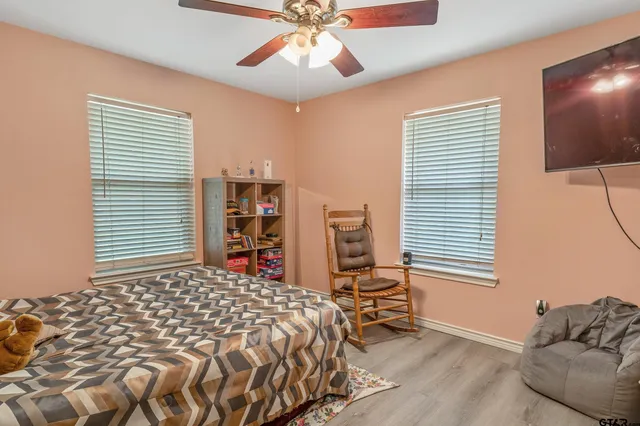 a bedroom with a bed and a chandelier