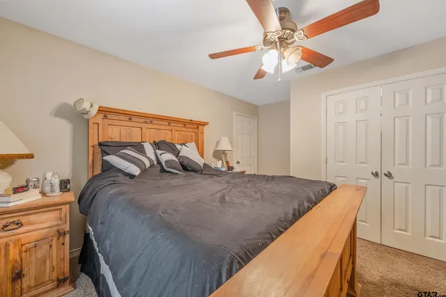 a bed sitting in a bedroom and chandelier
