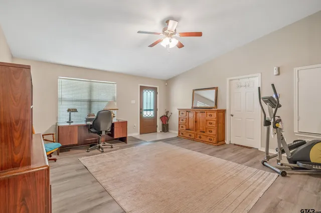 a view of a workspace with furniture and a gym