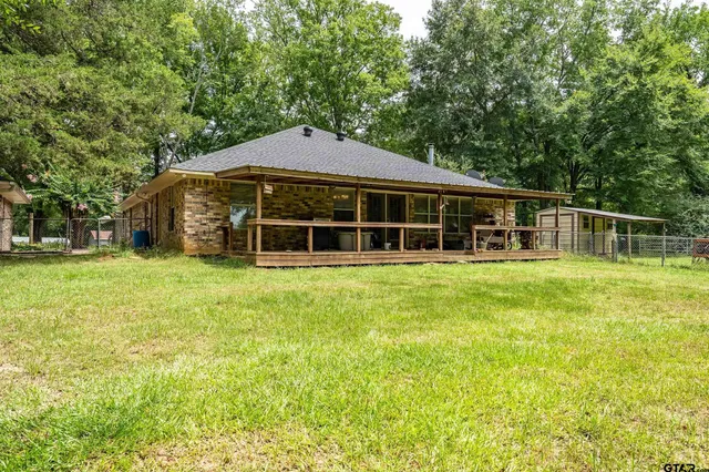 a view of a house with a backyard