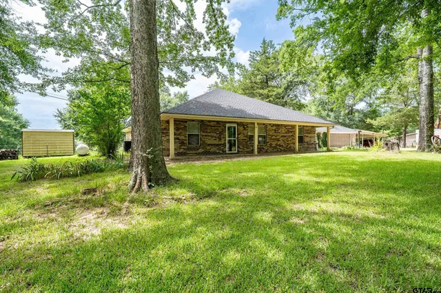 a view of a house with a backyard