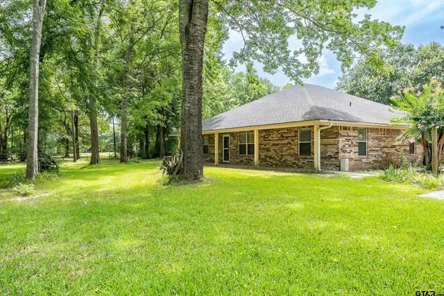 a view of a house with a backyard