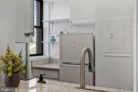 a kitchen with a refrigerator and a sink