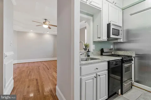 a kitchen with cabinets and stainless steel appliances
