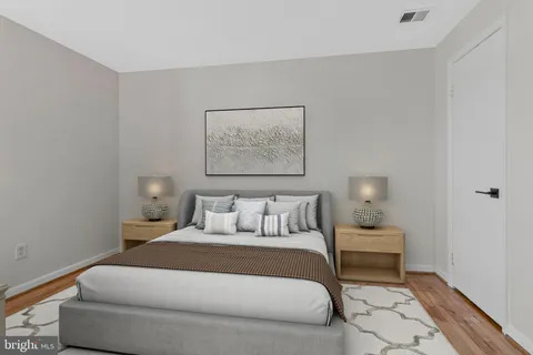 a bedroom with a bed and a night stand