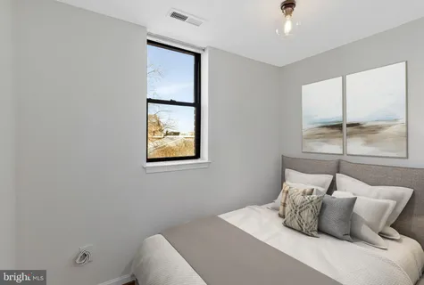 a bedroom with a bed and window