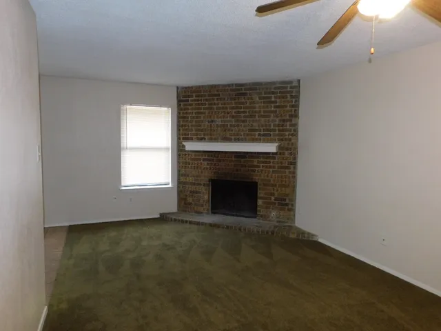 a view of empty room with a fireplace
