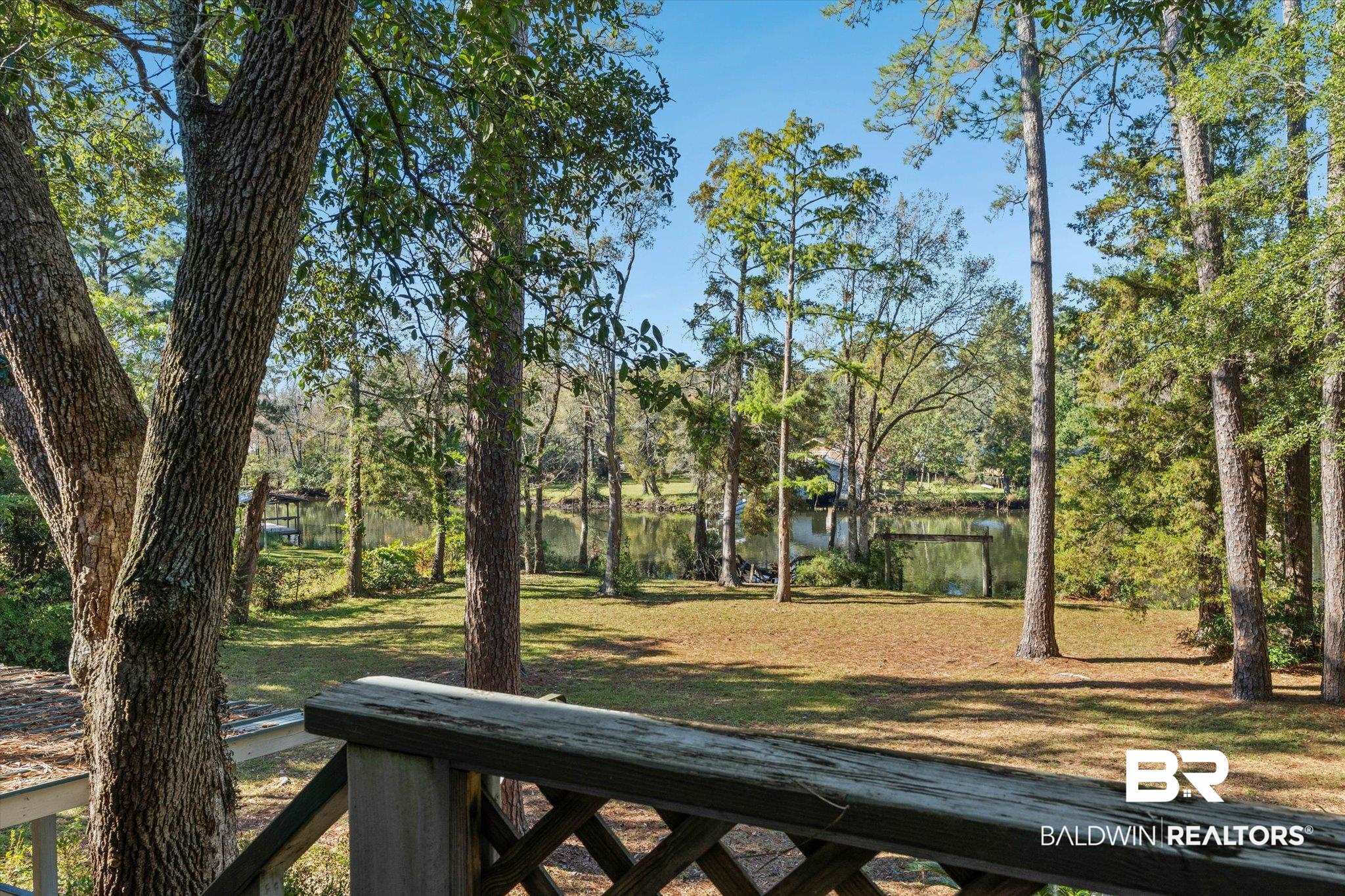 431 Simms Drive Saraland, AL 36571 - Photo 15 of 34 View of green lawn featuring a water view and view of wooded area