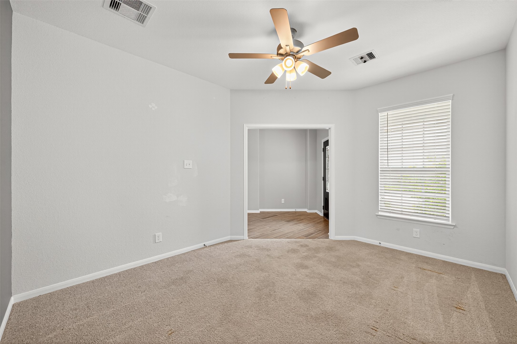 1312 Mainland Shores Lane Montgomery, TX 77316 - Photo 11 of 50 an empty room with chandelier fan and windows