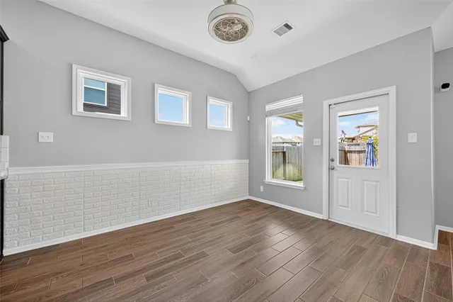 a view of an entryway with wooden floor