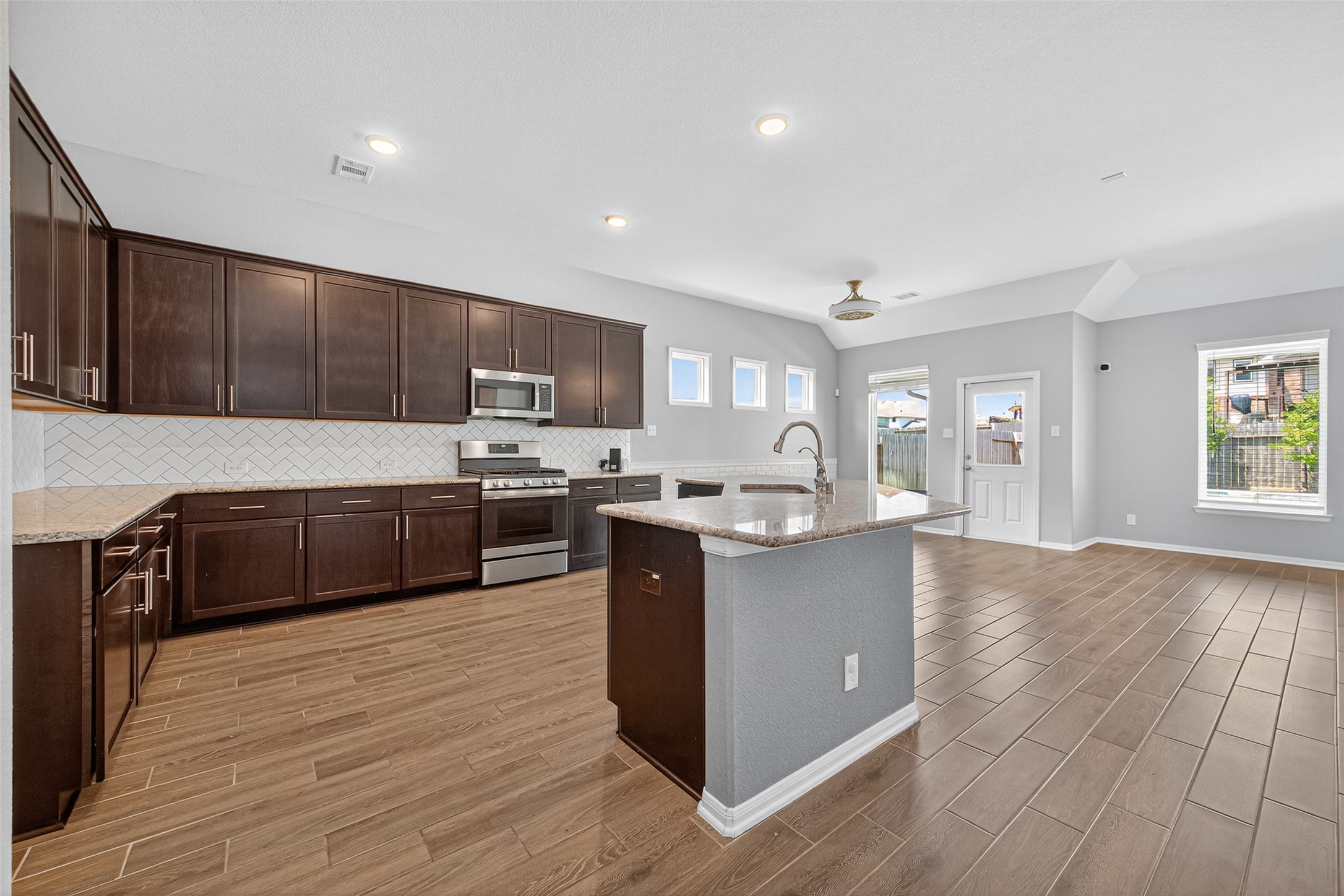 1312 Mainland Shores Lane Montgomery, TX 77316 - Photo 24 of 50 a large kitchen with stainless steel appliances granite countertop a large counter top and wooden floors