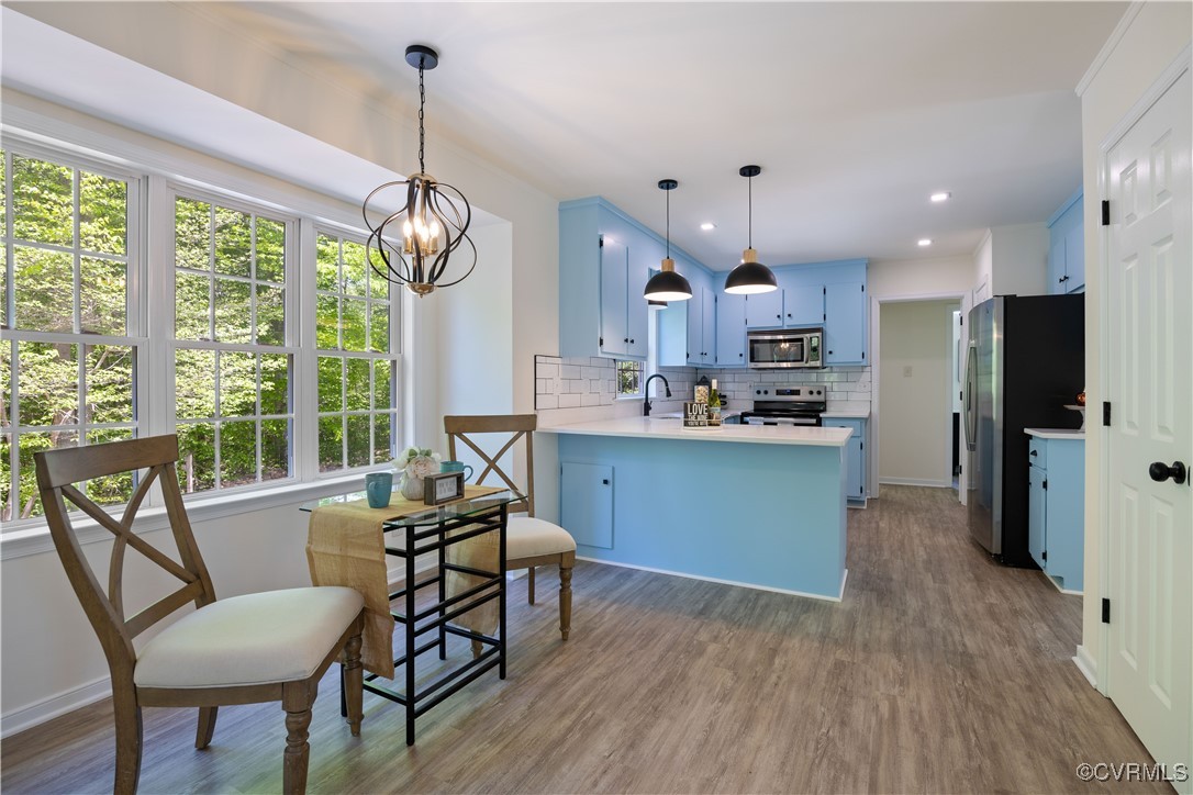 11730 Corte Castle Road Chesterfield, VA 23838 - Photo 16 of 50 Kitchen with blue cabinets, a peninsula, decorativ