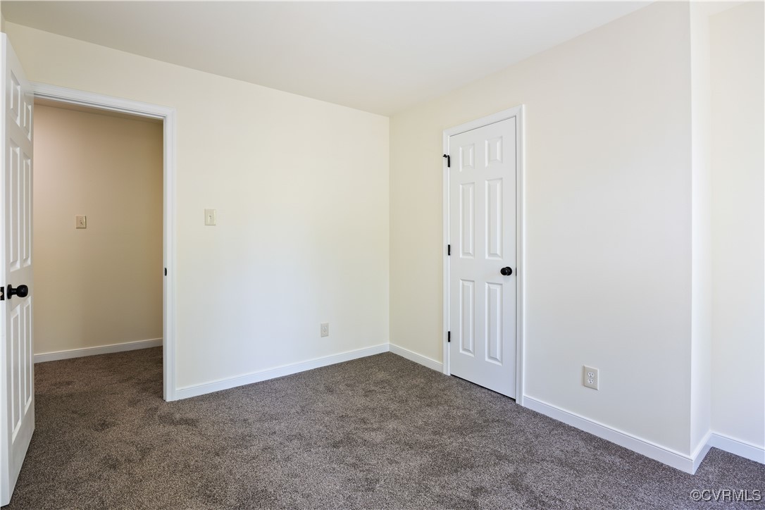 11730 Corte Castle Road Chesterfield, VA 23838 - Photo 21 of 50 Empty room with dark colored carpet and baseboards