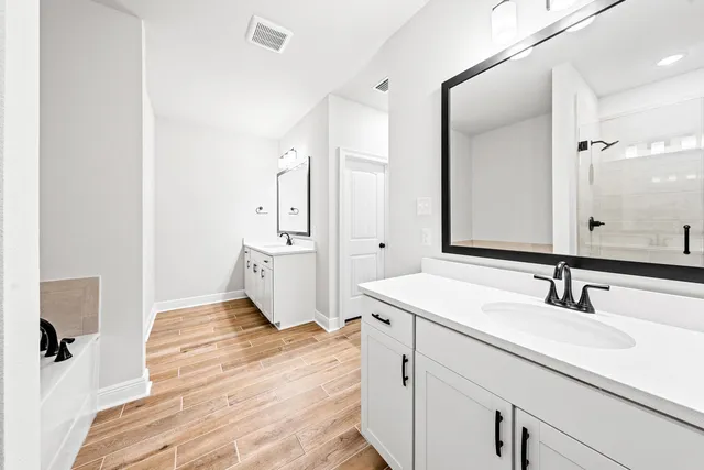 a spacious bathroom with a sink and a mirror