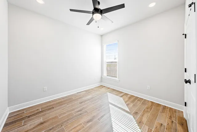 a view of room with window and wooden floor