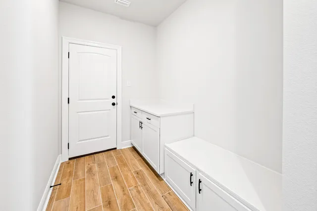 a view of a hallway with wooden floor