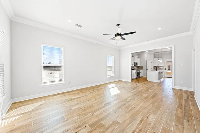 a view of empty room with wooden floor