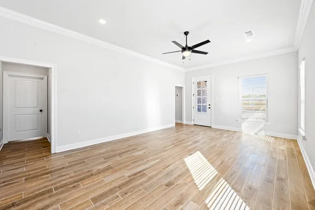 wooden floor in an empty room with a window