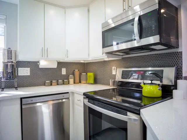 a kitchen with stainless steel appliances granite countertop a refrigerator and a stove
