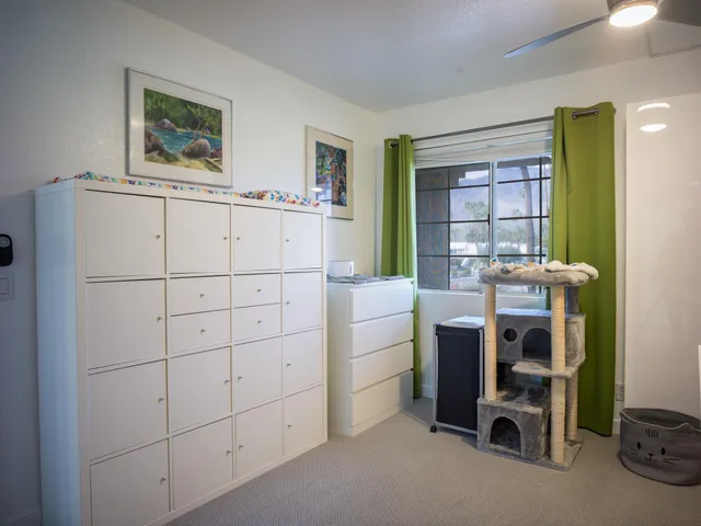a kitchen with a sink and a painting on the wall