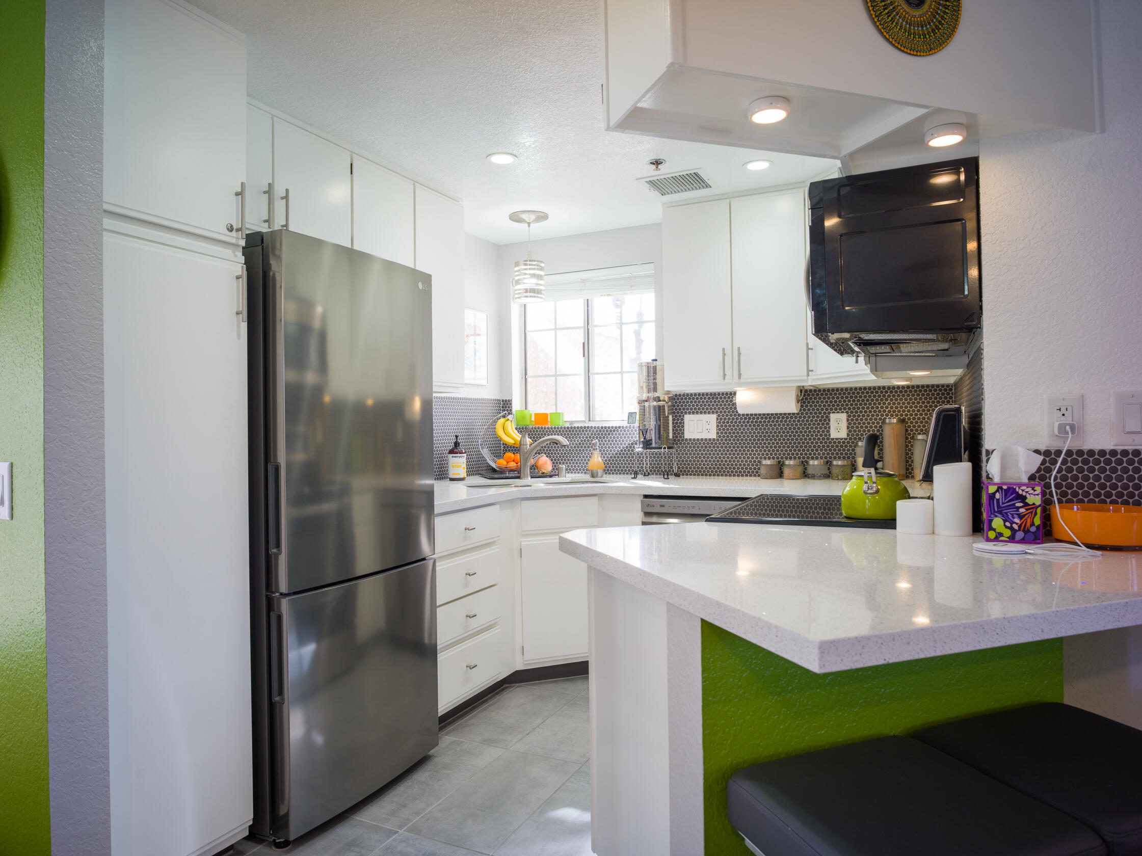 2700 Lawrence Crossley Road, Unit 7 Palm Springs, CA 92264 - Photo 9 of 28 a kitchen with kitchen island a sink stainless steel appliances and cabinets