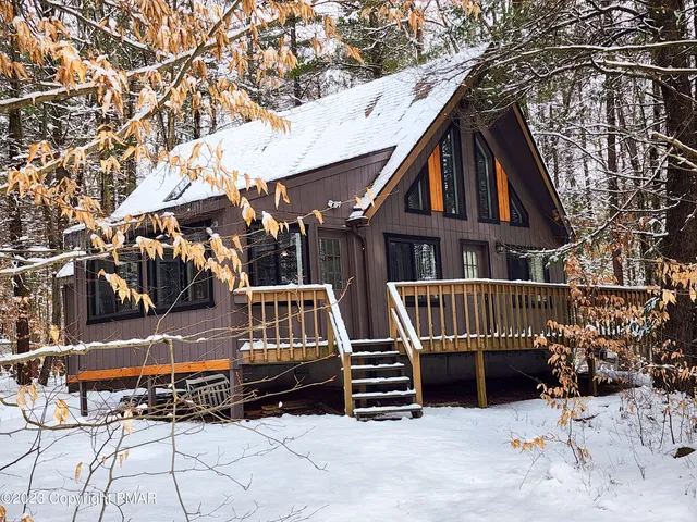 front view of a house with a bench