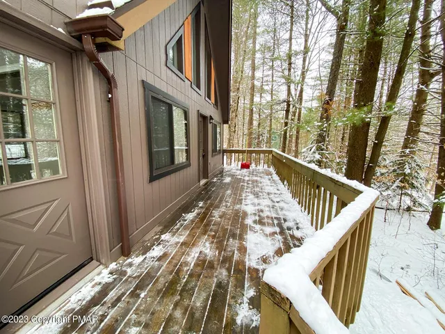a view of balcony with wooden floor and fence