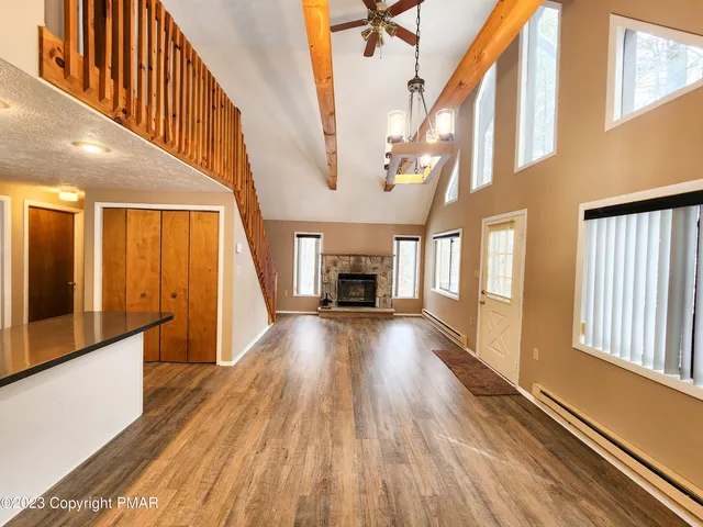 a view of hallway with wooden floor and fireplace