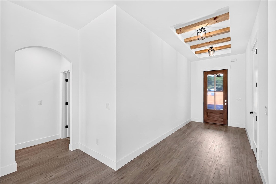 424 Blume Road Anderson, SC 29625 - Photo 6 of 30 A well-lit entry hall features rich wood flooring and a distinctive beamed ceiling with unique lighting.