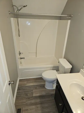 a bathroom with a double vanity sink toilet and