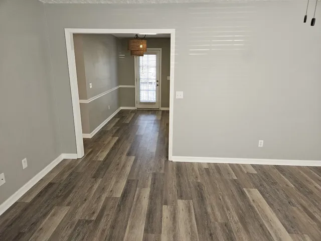 a view of a room with wooden floor and stairs