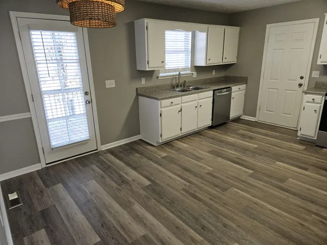 a view of a kitchen with a sink cabinets and a window