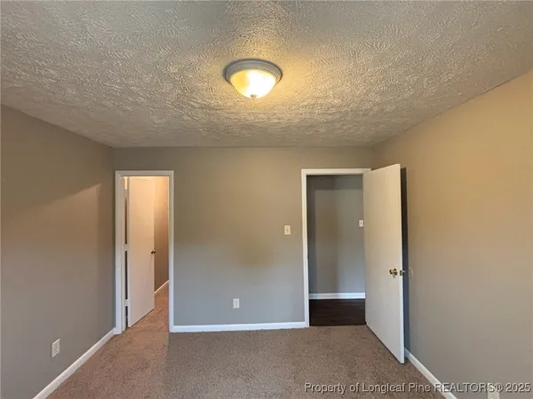 an empty room with closet area