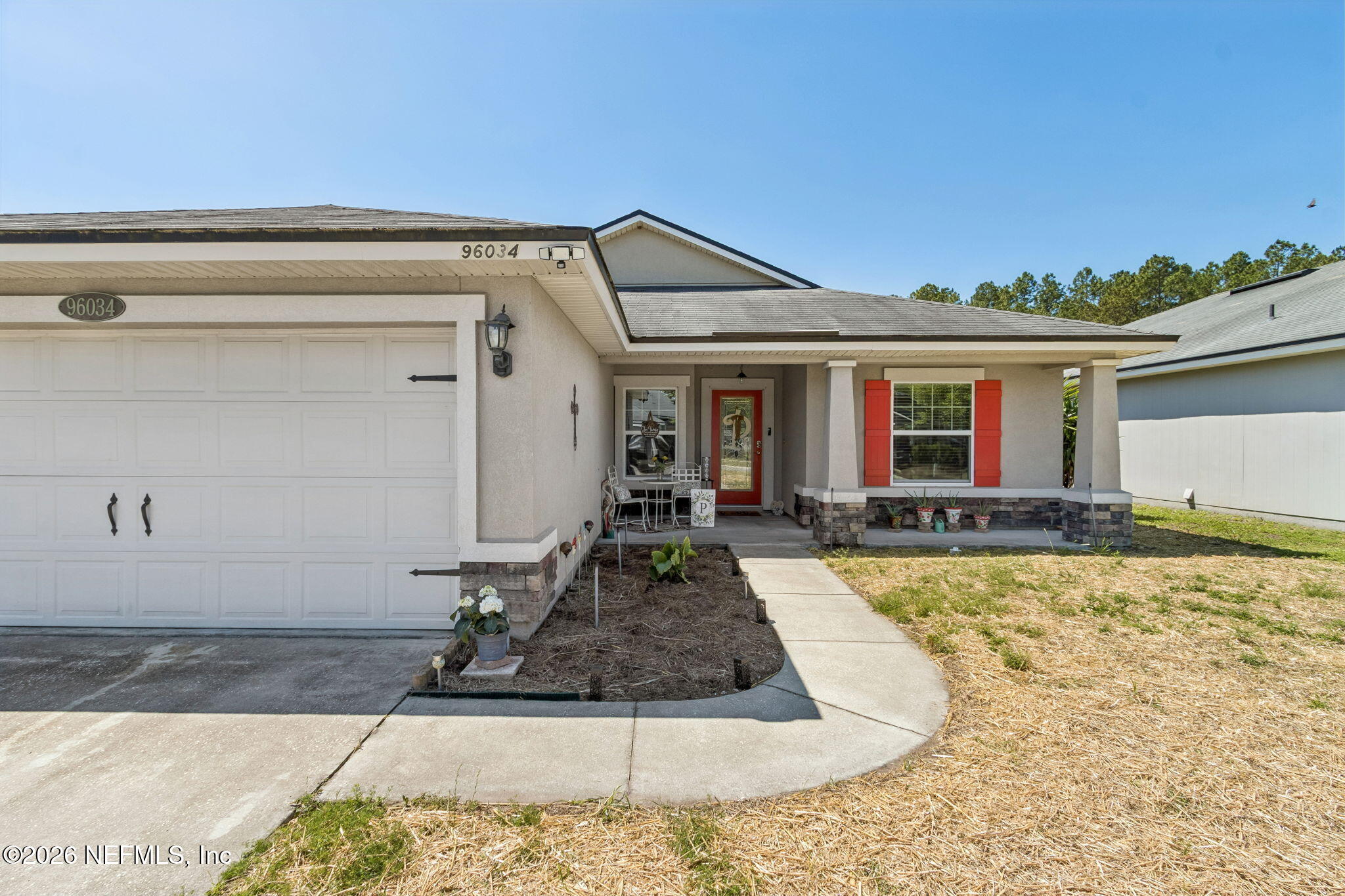 96034 Bass Lane Yulee, FL 32097 - Photo 6 of 50 front view of a house with a dry yard