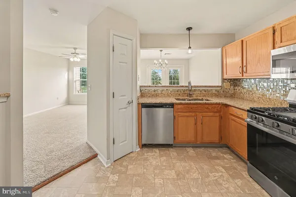 a kitchen with a sink stove and refrigerator