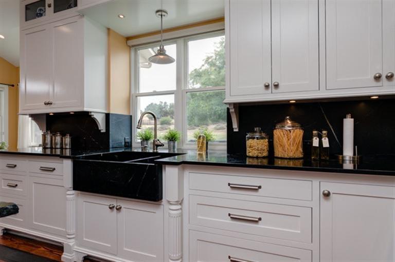 12751 Blue Heron Circle Ojai, CA 93023 - Photo 10 of 22 a kitchen with granite countertop white cabinets and black stainless steel appliances