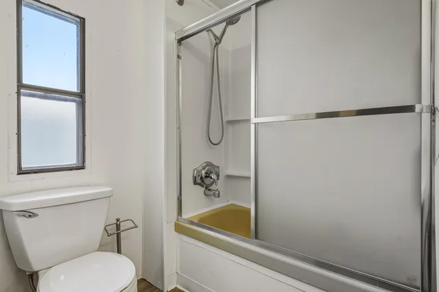 a bathroom with a shower a toilet and a sink