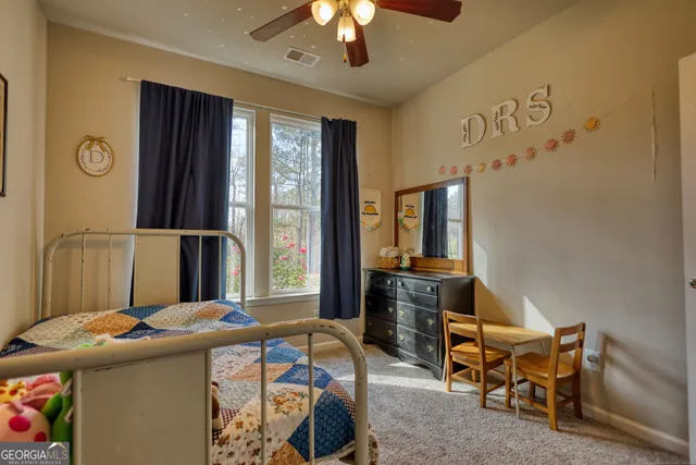 a bedroom with furniture and a window