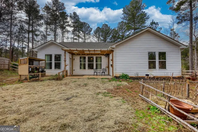 a view of a wooden chairs and a table in the backyard