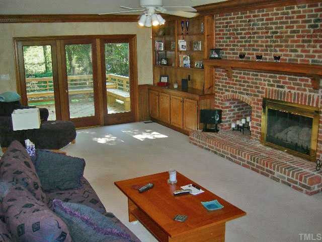 8800 Bickley Place Raleigh, NC 27613 - Photo 5 of 12 Large Family room with Brick FP, custom built ins, ceiling fan, lots of windows and door opens to the deck. Den/Family/Great Room