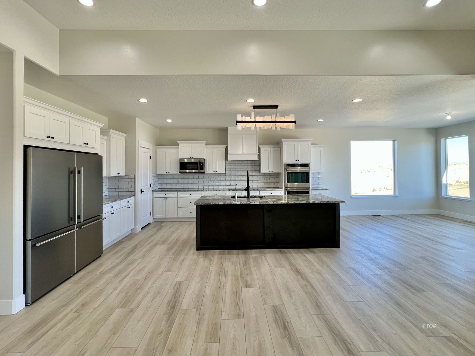 1597 Sun Vly Road, Unit C7 Spring Creek, NV 89815 - Photo 7 of 43 a large kitchen with a large counter top stainless steel appliances and a window