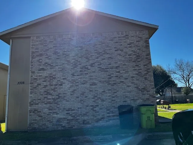 a brick building with a bench in front of it