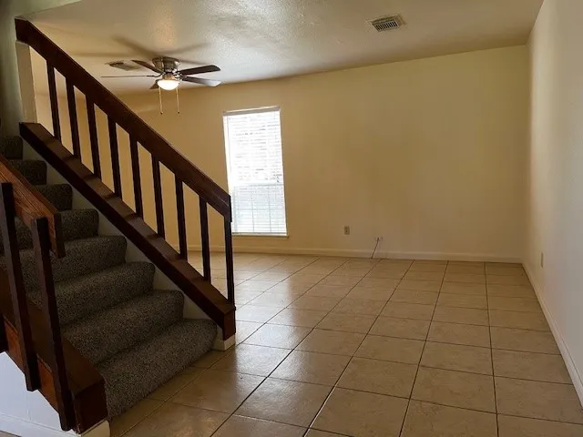 a view of an empty room with stairs
