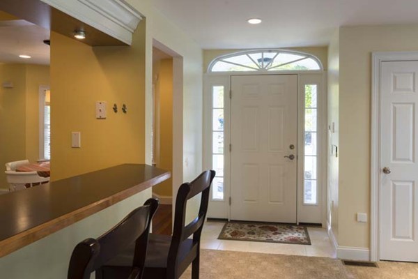 4 Prospect Road Andover, MA 01810 - Photo 16 of 30 a view of a hallway with windows and chandelier