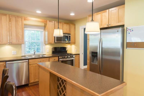4 Prospect Road Andover, MA 01810 - Photo 3 of 30 a kitchen with stainless steel appliances granite countertop a refrigerator a sink dishwasher a stove and a refrigerator with wooden floor