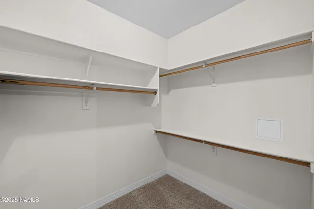 a view of a house with a small yard and wooden fence